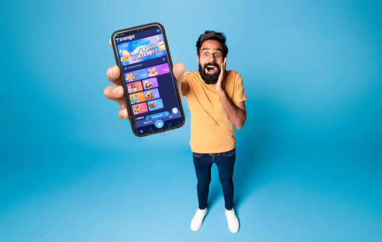 indian man showing his tiranga games online app on his phone