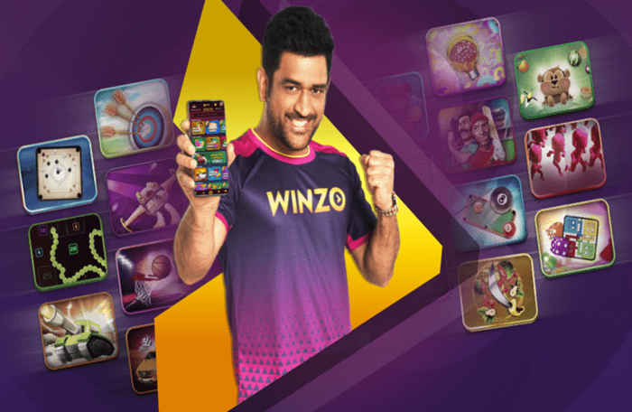 an image of a man showing his phone with winzo app showing that winzo app is a safe and legitimate game